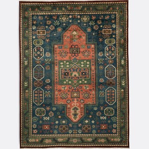 May include: A rectangular area rug with an intricate, symmetrical design. The rug features a deep blue field with a central, stylized medallion in shades of rust, green, and cream. The border is a darker green with floral and geometric patterns.