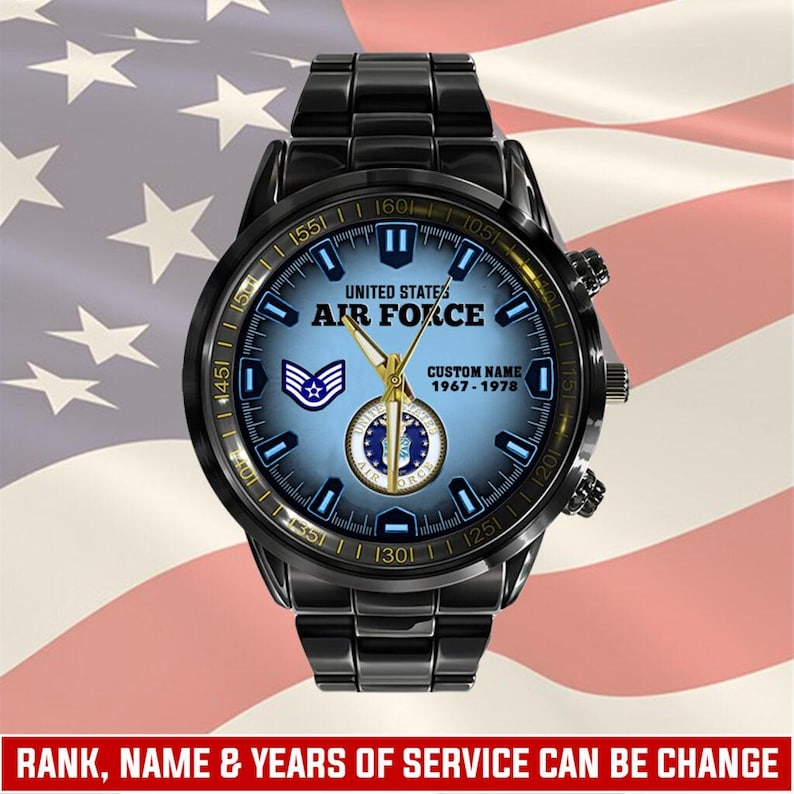 May include: A black stainless steel wristwatch with a blue gradient dial featuring the United States Air Force logo, a rank insignia, and customisable text including "UNITED STATES AIR FORCE", "CUSTOM NAME", and the years "1967 - 1978".