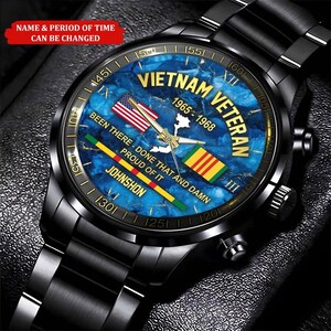 May include: Black wristwatch with a blue face featuring the text "Vietnam Veteran 1965-1968". The watch face includes an American flag, a Vietnam flag, and the words "Been There - Done That and Damn Proud of It".