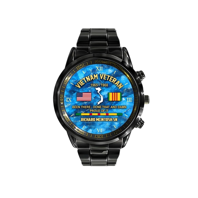 May include: Black wristwatch with a blue face featuring the text "Vietnam Veteran 1965-1968". The watch face includes the American and Vietnamese flags. The watch band and case are black.