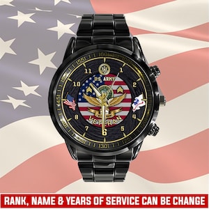 May include: A black stainless steel wristwatch featuring a dark wood-grain dial with the U.S. Army emblem, a golden eagle, and the word VETERAN. The face displays a central American flag graphic, gold-tone hands, and numerical hour markers.