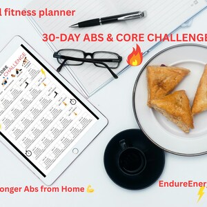 May include: A digital fitness planner on a tablet, displaying a 30-day abs and core challenge. The image includes a pen, glasses, a plate with pastries, and a cup of coffee. Text reads "Digital fitness planner" and "Build Stronger Abs from Home."