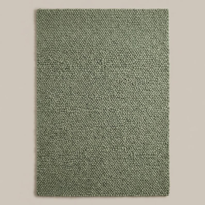 Handwoven chunky knit wool rug in neutral green tone, modern Scandinavian floor rug for warm and cozy interiors