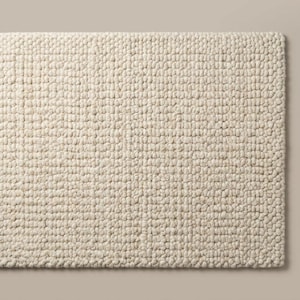 Neutral ivory wool area rug with textured surface for modern organic home interiors