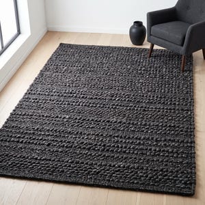 May include: A rectangular area rug featuring a dark charcoal gray color and a thick, chunky, hand-knotted texture with prominent raised loops arranged in horizontal rows across the entire surface of the floor covering.