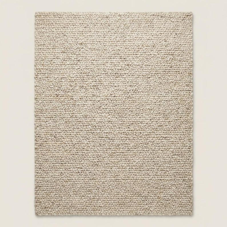 Handmade style chunky wool rug adding warmth and depth to modern Scandinavian home interior