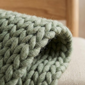 Chunky wool rug with thick braided texture, handmade from natural wool, perfect for cozy living room or minimalist home decor