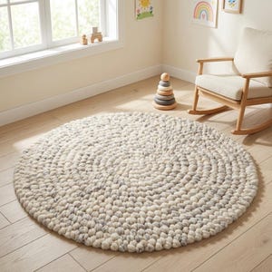 Soft chunky wool pebble rug in cream and light gray tones, handmade textured wool rug for modern living room decor