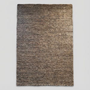 Handwoven natural wool area rug featuring chunky weave and earthy colors, ideal for cozy boho or Scandinavian interior designs