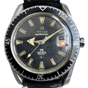 May include: Vintage Titoni Seascoper watch with a black dial, luminous markers, and a date window at 3 o'clock. The watch features a black rotating bezel and a black leather strap. The dial reads "25 Jewels 660 ft."