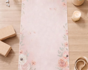 May include: A pink yoga mat with a floral design featuring roses and other flowers. The mat has the name "Olivia Smith" printed on it. Other items include a water bottle, ear buds, yoga blocks, a candle, and a yoga strap.