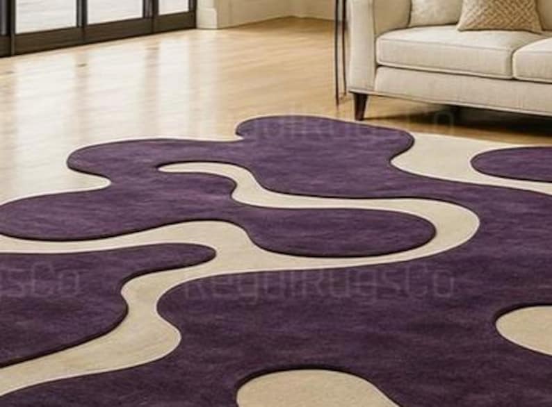 Modern Purple Abstract Wavy Rug in deep plum and beige tones, featuring curved organic shapes. Large 12x15ft contemporary area carpet perfect for living rooms or bedrooms, adding artistic style, warmth, and sophistication to any modern home interior.