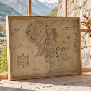 May include: A framed map of Middle Earth, with detailed illustrations of the fictional world. The map is displayed on a wooden surface near a window with a mountain view. Two white vases with dried plants are on the right.