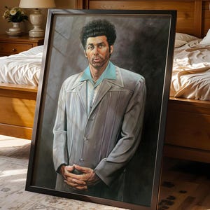 May include: A framed portrait of a man in a light gray suit with a light blue collar. The artwork is leaning against a bed in a bedroom with wooden furniture and a patterned rug. The portrait is in a dark wooden frame.