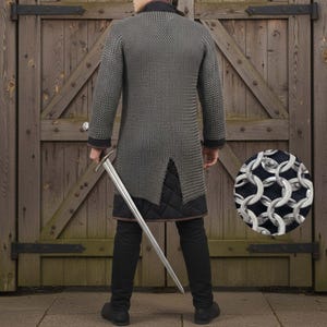 May include: A silver chainmail shirt with long sleeves and a split hem, worn over black pants and a quilted undergarment. A long silver sword is held at the side. The background is a wooden door.