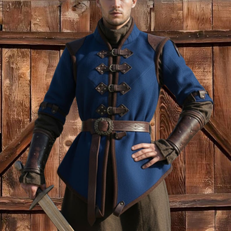 May include: A blue medieval-style tunic with brown leather accents, shoulder pads, and a belt. The tunic features decorative buckles down the front and leather arm guards. The outfit is designed with a high collar and long sleeves.