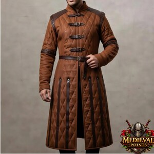 May include: A brown quilted coat with leather accents, buckles, and a belt. The coat features a diamond pattern, shoulder and sleeve detailing, and a high collar. The design is reminiscent of medieval attire.