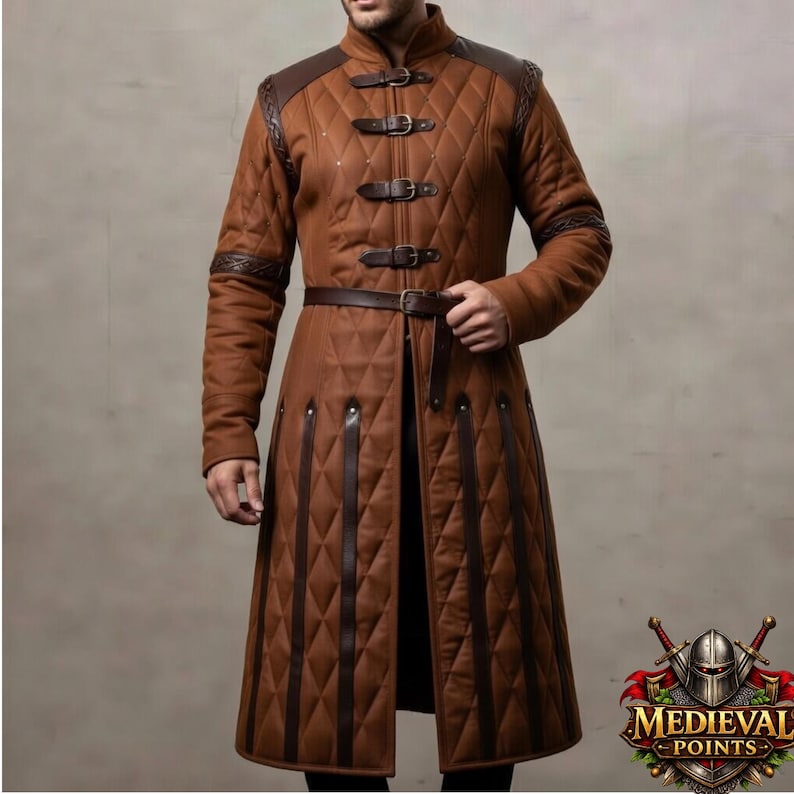 May include: A brown quilted coat with leather accents, buckles, and a belt. The coat features a diamond pattern, shoulder and sleeve detailing, and a high collar. The design is reminiscent of medieval attire.