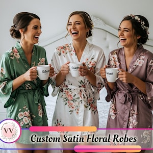 May include: Three women wearing custom satin floral robes in green, white, and mauve, each holding a white mug. The robes have a floral pattern. The image includes the text "Custom Satin Floral Robes".