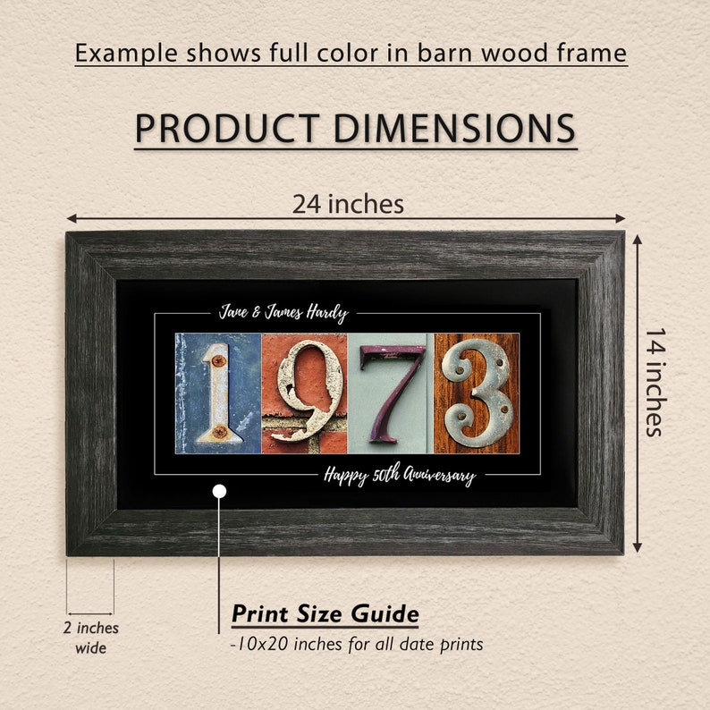 May include: A framed print with a black background and a vintage-style design featuring the year 1973 in colorful, weathered metal letters. The print includes the names "Jane & James Hardy" and the text "Happy 50th Anniversary". The frame is a dark gray wood with a distressed finish. The print measures 10 inches by 20 inches and is framed to a size of 14 inches by 24 inches.