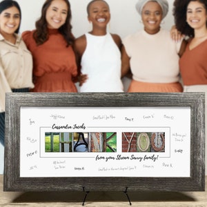 May include: A framed print with a collage of photos spelling out "THANK YOU" with a handwritten message below that reads "from your Stream Sarvy family!"  The print is surrounded by a gray frame and has handwritten messages around the border.