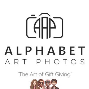 May include: Black and white logo for Alphabet Art Photos, a photography business. The logo features a stylized camera with the letters "AAP" inside a circle. The text "Alphabet Art Photos" is below the logo, and the tagline "The Art of Gift Giving" is below the text.