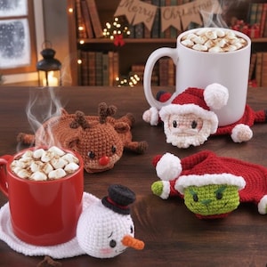 May include: A cozy holiday scene with mugs of hot chocolate topped with marshmallows, resting on handmade crochet coasters. The coasters feature festive designs like Santa, a snowman, a reindeer, and a Grinch, perfect for Christmas.