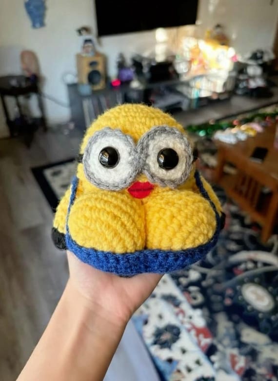 A hand-crocheted Minion with adult-humor energy — someone actually sat down and made this filthy little guy stitch by stitch.