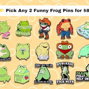 May include: A selection of novelty frog pins in various designs. The pins feature frogs in different poses and with humorous text, such as "Man, I love frogs" and "Froggy Juice." The pins are brightly coloured and eye-catching.
