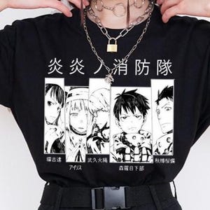 May include: Black t-shirt with a manga-style graphic featuring Japanese text and character illustrations. The shirt has a crew neck and short sleeves. The graphic includes several anime characters and Japanese text.