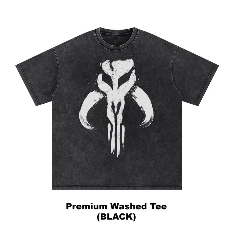 May include: Black washed tee shirt with a white graphic design. The graphic is a stylized symbol with curved lines and vertical strokes. The text at the bottom reads "Premium Washed Tee (BLACK)".