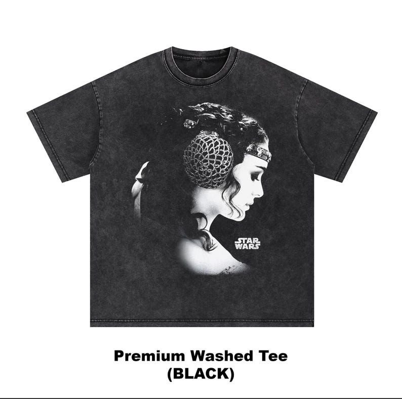 May include: Black washed tee featuring a grayscale portrait of a woman with a decorative headpiece, a profile view, and the Star Wars logo. The text "Premium Washed Tee (BLACK)" is printed at the bottom.