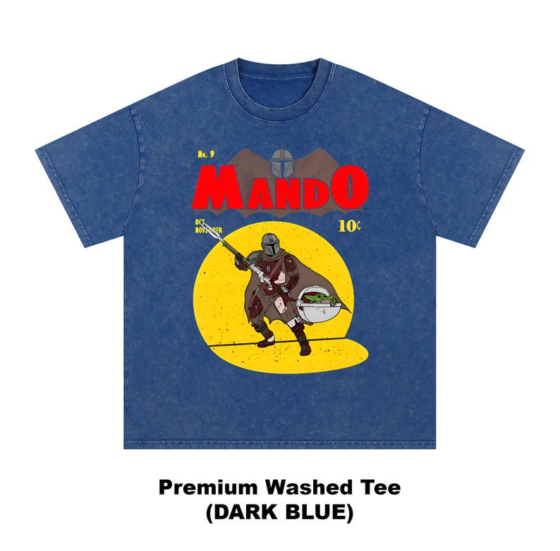 May include: Dark blue premium washed tee featuring a comic book style graphic. The graphic includes the word "MANDO" in red, a yellow circle with a character holding a weapon, and the text "10&cent;".