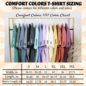 May include: A color chart for Comfort Colors T-shirts, featuring various colors like Light Green, Blue Jean, and Berry. The chart includes sizing information for widths ranging from 18.25 to 27.75 inches, lengths from 26.62 to 32.5 inches, and sleeve lengths from 16.25 to 23.25 inches.