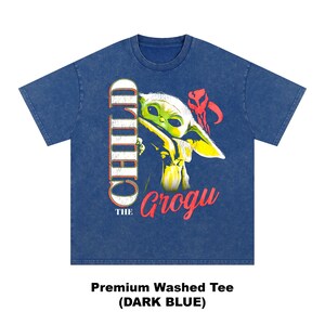 May include: Dark blue premium washed tee featuring a graphic of Grogu, also known as The Child, from The Mandalorian. The graphic includes the word "CHILD" in white and the name "Grogu" in red.