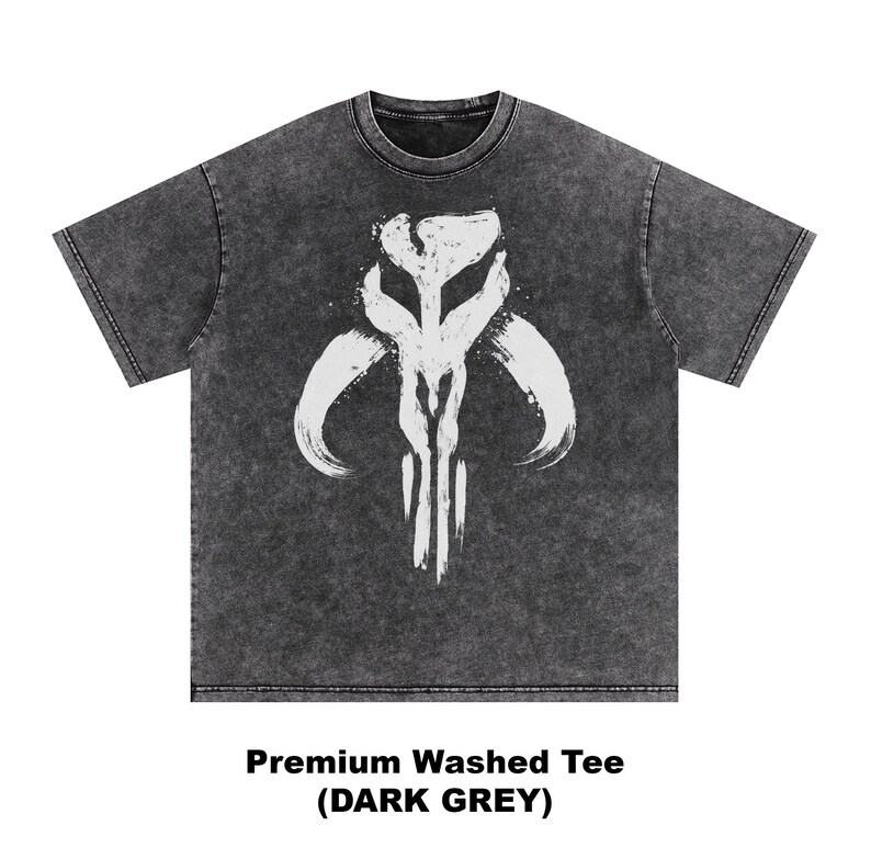 May include: Dark grey, washed t-shirt featuring a white graphic design. The design is a stylized, symmetrical emblem with curved horns and vertical lines. The text "Premium Washed Tee (DARK GREY)" is printed below the shirt.