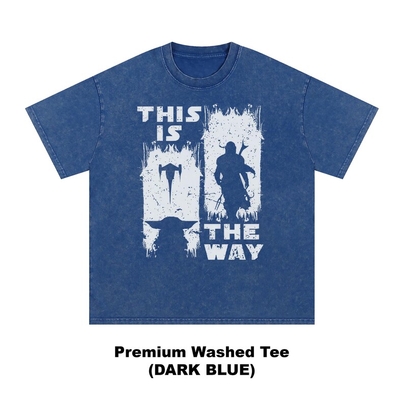 May include: Dark blue t-shirt with a white graphic featuring a spaceship, a silhouette of a character, and the text "THIS IS THE WAY". The shirt is a premium washed tee.