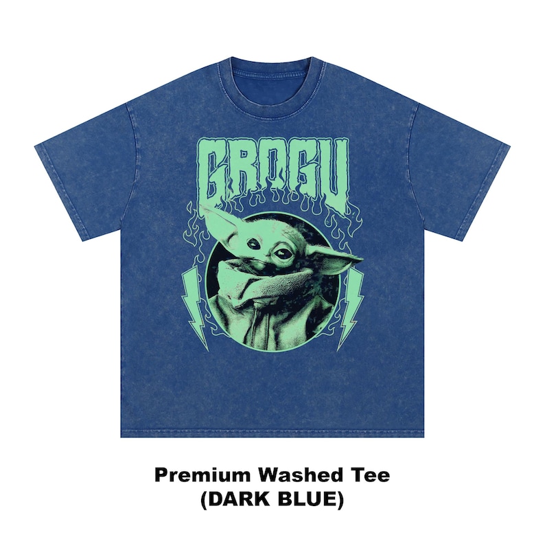 May include: Dark blue premium washed tee featuring a graphic of Grogu, with the word "GROGU" in green above the image. The image of Grogu is in a circle with green lightning bolts on either side. The shirt is dark blue.