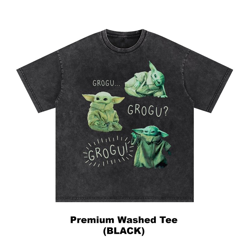 May include: Black washed tee featuring four Grogu illustrations in green. The shirt has the text "GROGU...", "GROGU?", and "GROGU!" in white. The bottom of the shirt reads "Premium Washed Tee (BLACK)".