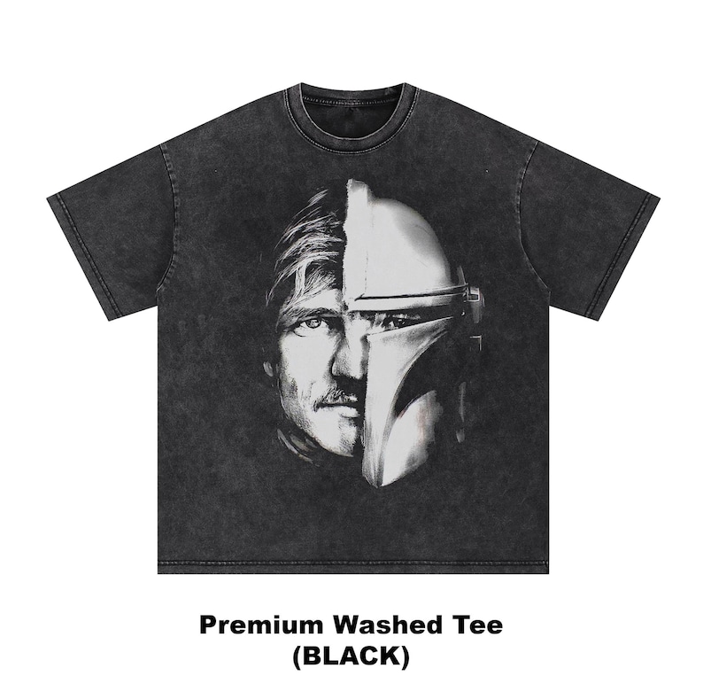 May include: Black washed tee featuring a split face design. One half of the design is a man's face with a mustache, and the other half is a helmet. The text "Premium Washed Tee (BLACK)" is at the bottom of the shirt.