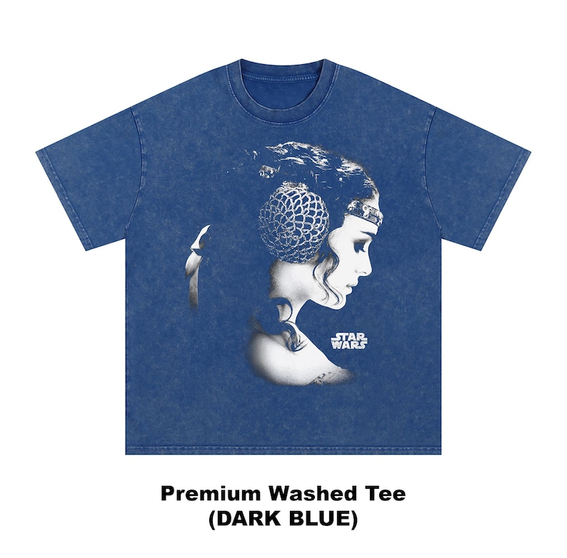 May include: Dark blue t-shirt featuring a black and white graphic of a woman's profile with a decorative headpiece. The Star Wars logo is visible. The text "Premium Washed Tee (DARK BLUE)" is printed at the bottom.