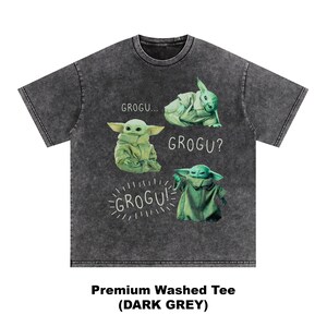 May include: Dark grey, washed tee shirt featuring Grogu from The Mandalorian. The shirt has four images of Grogu with the text "GROGU...", "GROGU?", and "GROGU!". The shirt also has the text "Premium Washed Tee (DARK GREY)".