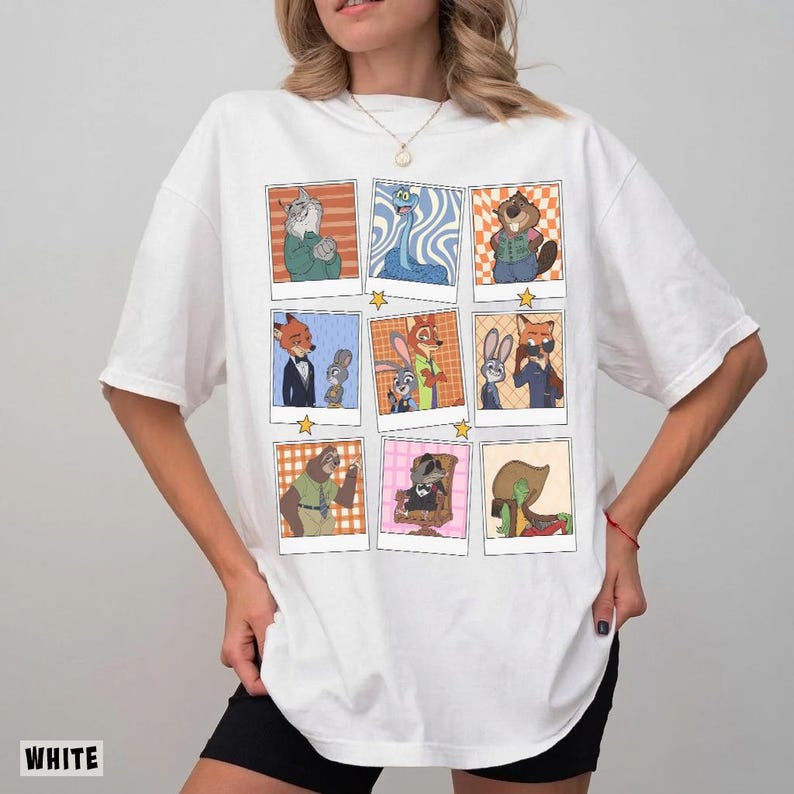 May include: White t-shirt featuring a grid of cartoon character portraits in polaroid-style frames. The illustrations depict various animals in colorful outfits, with a star graphic between each frame. The word "WHITE" is printed at the bottom left.