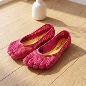 May include: A pair of bright pink five-toe shoes featuring a breathable mesh upper, a yellow interior insole, and a durable Vibram rubber sole. The design includes individual toe compartments and a low-cut opening for a flexible fit.