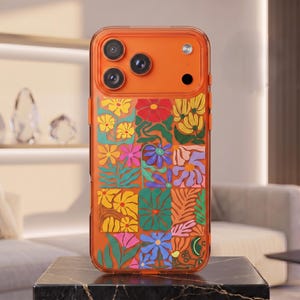 May include: A translucent orange smartphone case featuring a vibrant grid of colorful floral and botanical illustrations. The design includes various stylized flowers in shades of red, yellow, pink, blue, and green, with a clear camera cutout area.