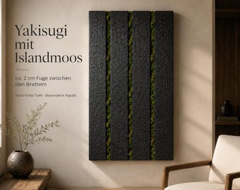 May include: A Yakisugi wall art piece with charred black wooden panels and green moss inserts. The text "Yakisugi mit Islandmoos" is displayed. The panels are separated by approximately 2 cm. The piece has a textured finish.