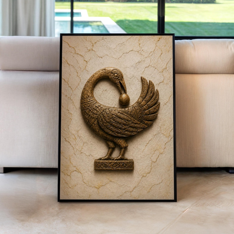 a large, ornate gold bird sculpture with a beak and wings, displayed in a frame on a beige surface.