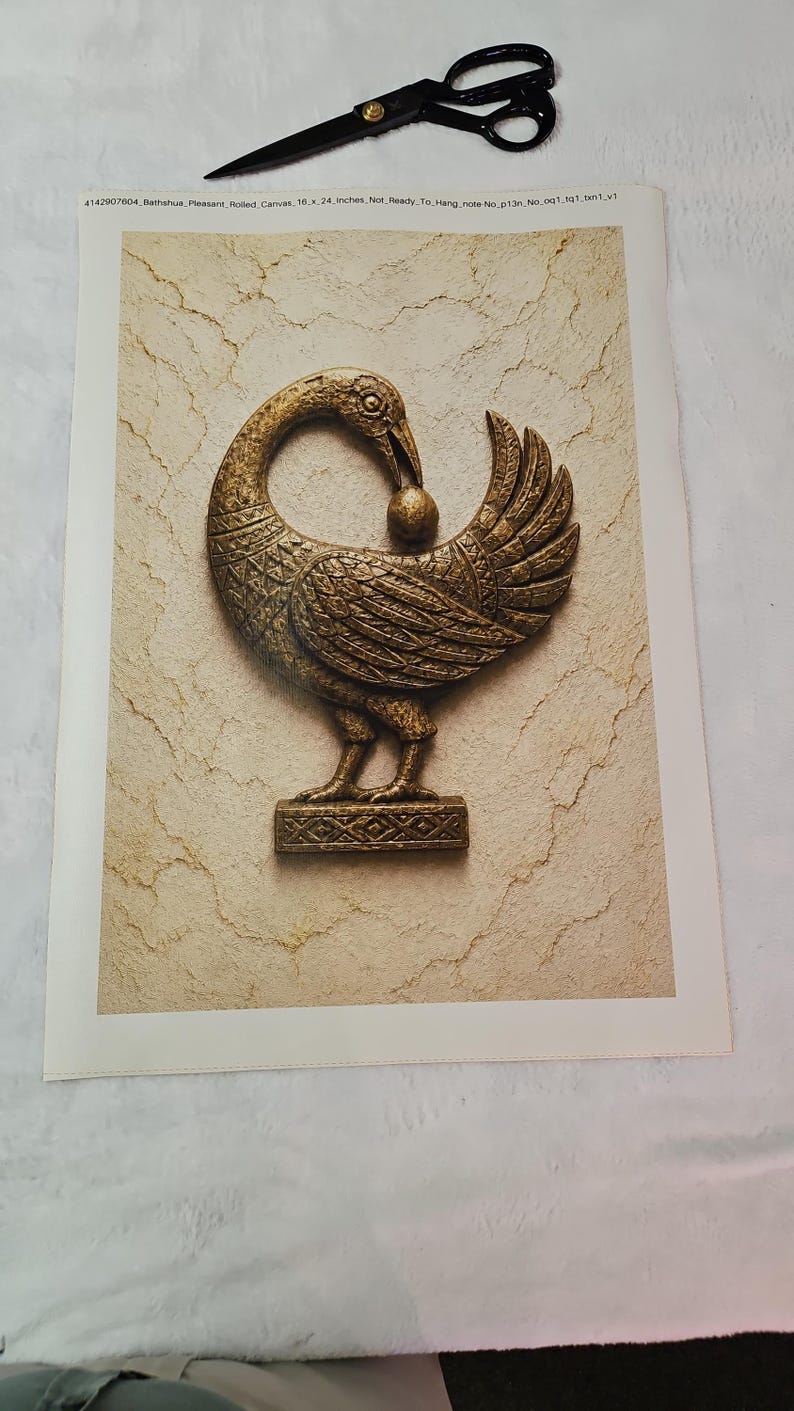 a close-up of a decorative bronze sculpture of a bird, possibly a swan or goose, with a ball in its beak.