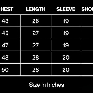 May include: A size chart in white text on a black background, detailing chest, length, sleeve, and shoulder width measurements in inches for sizes S to XXL. The text "Size in Inches" is at the bottom.
