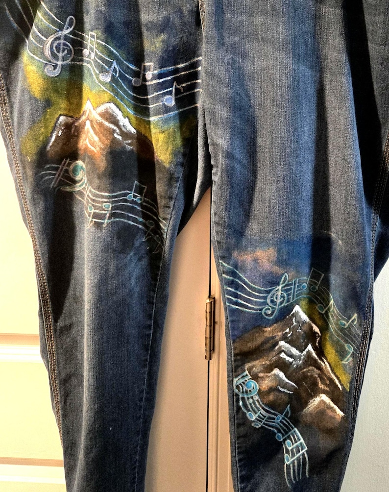 May include: A white ceramic mug with a black handle and the text "But First, Coffee" in a bold, black font. The mug is sitting on a wooden surface. The mug is approximately 4 inches tall.